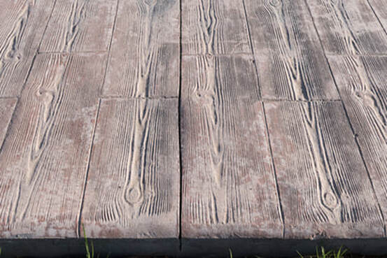 Stamped concrete made to look exactly like wood. Just be careful, it's still just as tough as concrete!